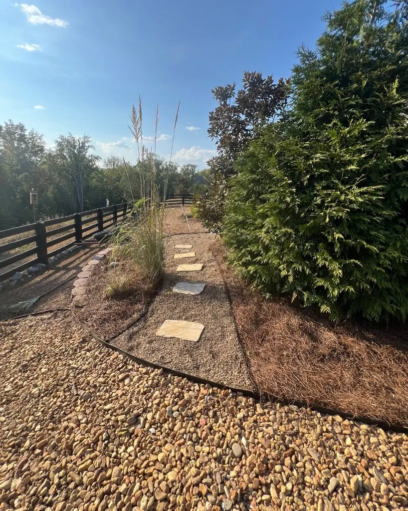 Pea gravel walkway with stepping stones and pine straw beds from another angle in College Grove, Tennessee