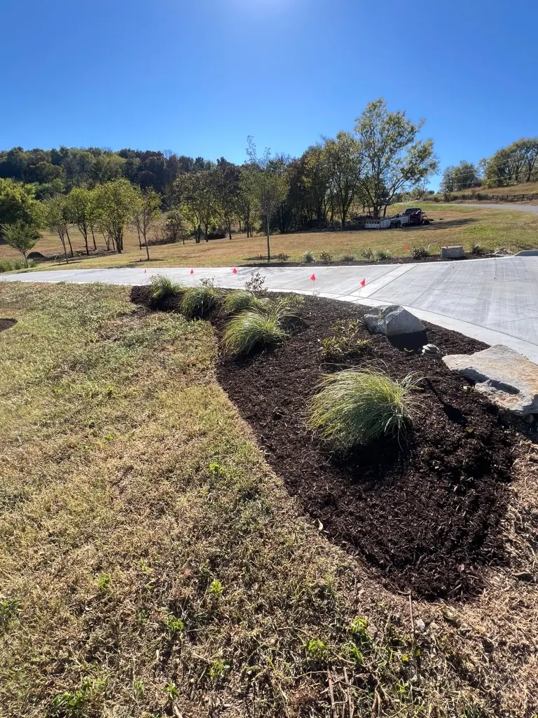 Front entrance and driveway landscape bed shaped, edged, and finished with brown mulch in College Grove, Tennessee