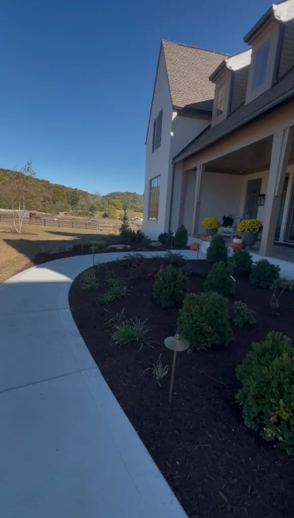 Front entrance landscape bed cleaned, edged, and finished with brown mulch in College Grove, Tennessee