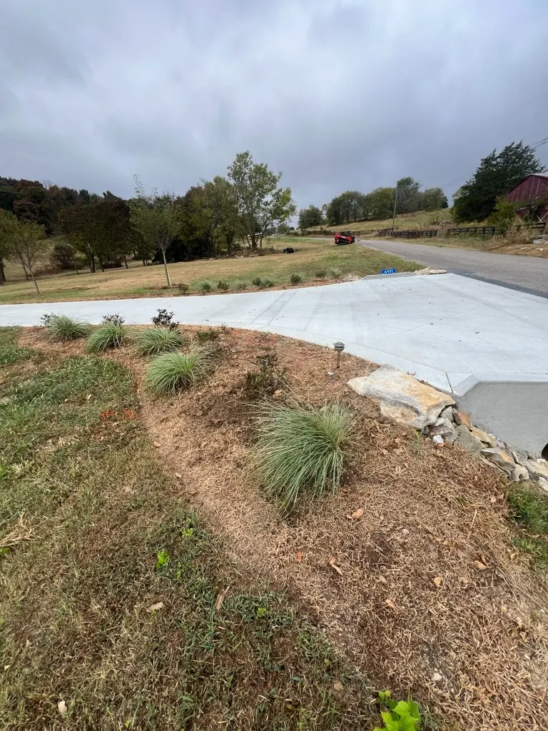 Front entrance and driveway landscape bed before shaping and brown mulch in College Grove, Tennessee