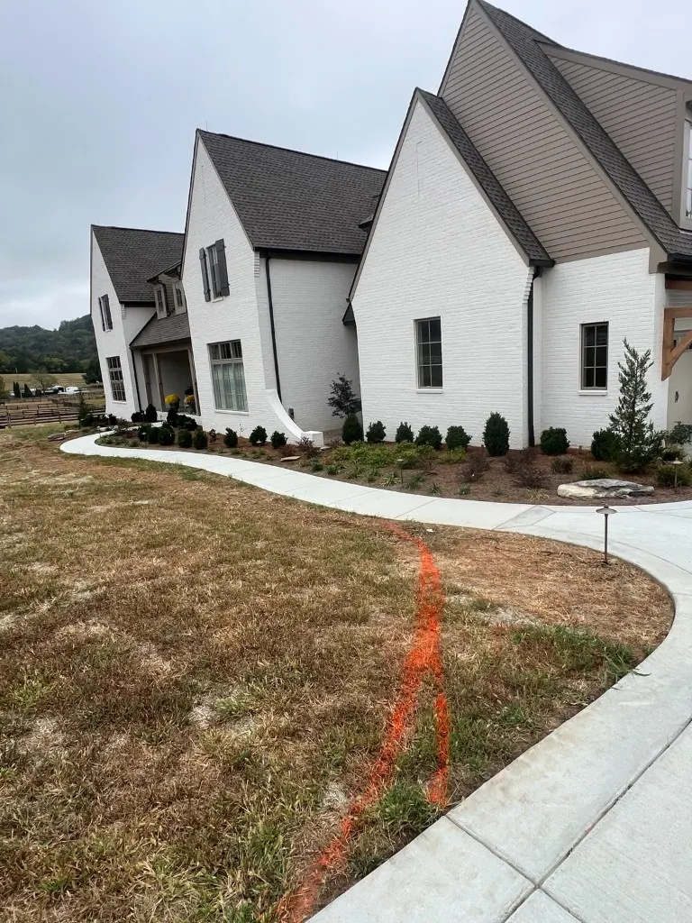 Front and side lawn edge marked for landscape bed extension in College Grove, Tennessee