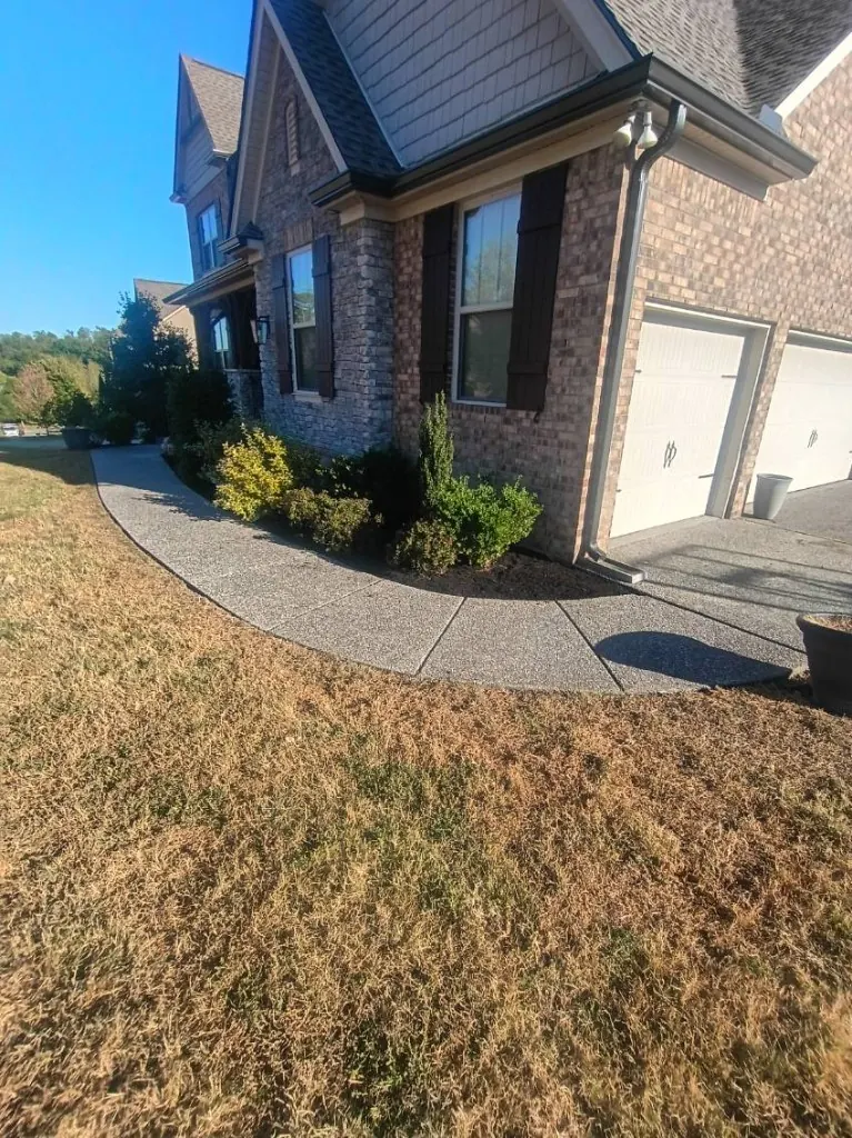 Front landscape bed after cleanup, shaping, and fresh mulch installation in College Grove, Tennessee