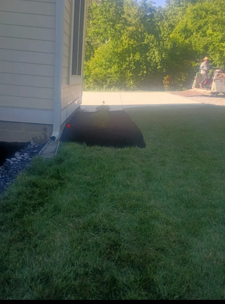 Completed mulch and planting bed beside a home in College Grove, Tennessee
