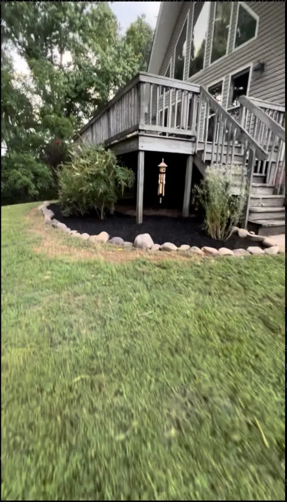Fresh black mulch around backyard deck landscaping in Columbia, TN