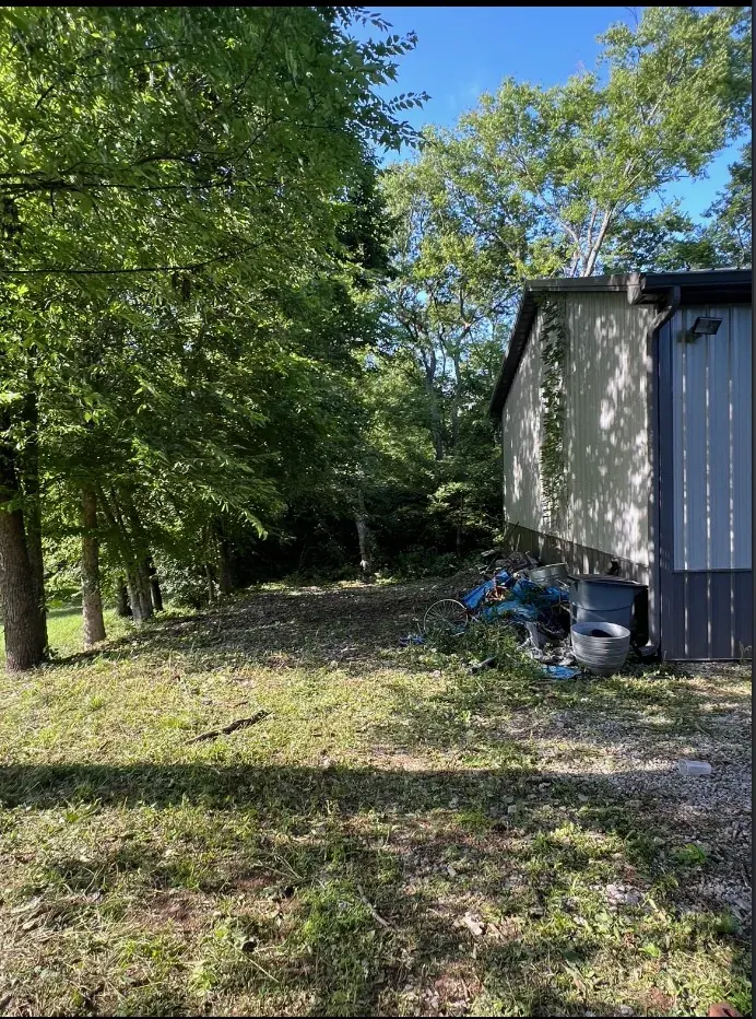 Cleared ground along the building after brush removal in Franklin, Tennessee