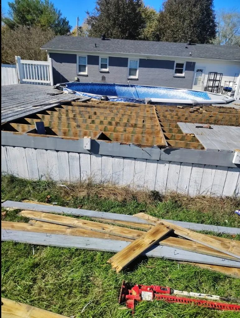 Wood deck being dismantled around above-ground pool in Spring Hill, TN